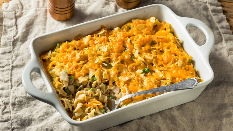 Tuna noodle casserole in a white dish on a table cloth