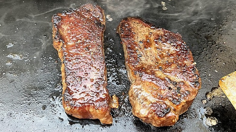 Two steaks are seared on a Blackstone Griddle
