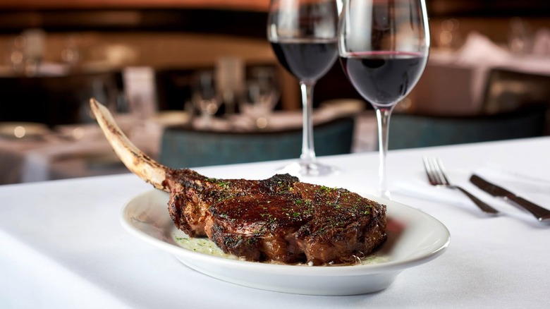 The 40-ounce prime tomahawk ribeye with two wine glasses from Ruth's Chris Steak House.