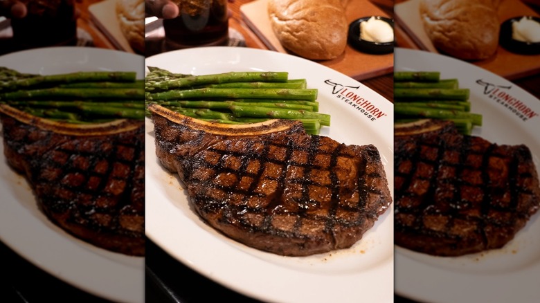 The Outlaw Ribeye at LongHorn Steakhouse served with asparagus.