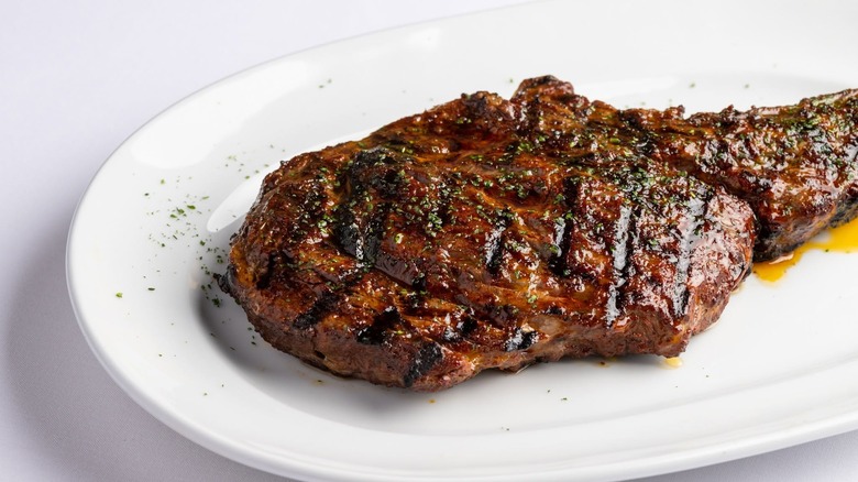 The bone-in ribeye at Steak 48 on a white plate