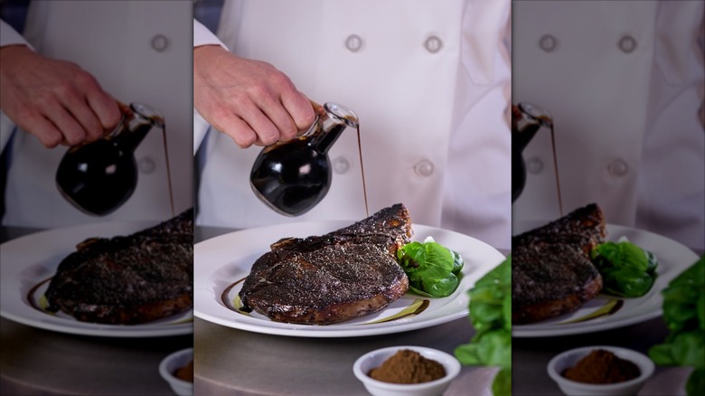 Chef pouring balsamic over the porcini‑rubbed bone‑in ribeye at The Capital Grille.