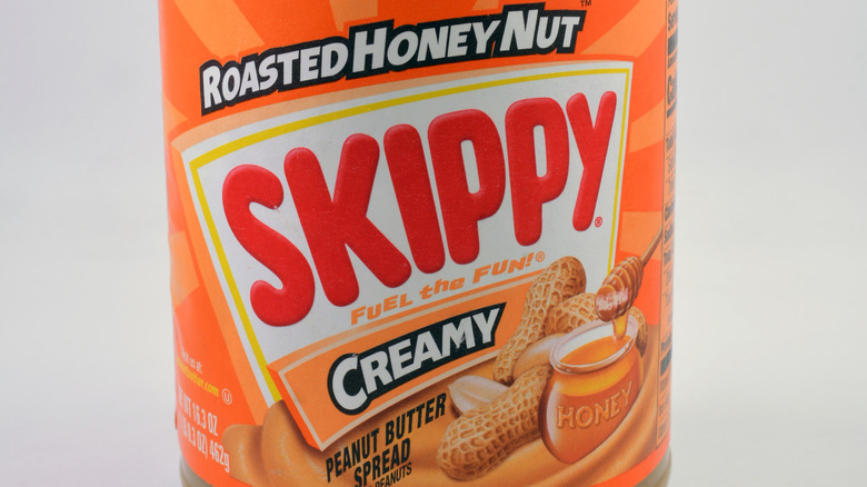 Close-up of the label on a jar of Skippy Roasted Honey Nut Creamy Peanut Butter Spread