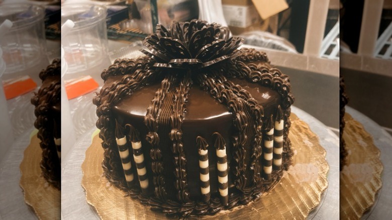 A Chocolate Ganache Supreme Cake from Publix sits on a golden cake board