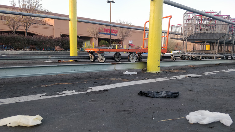 Discarded gloves litter the parking lot of a Costco