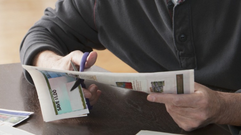 Person clipping coupons