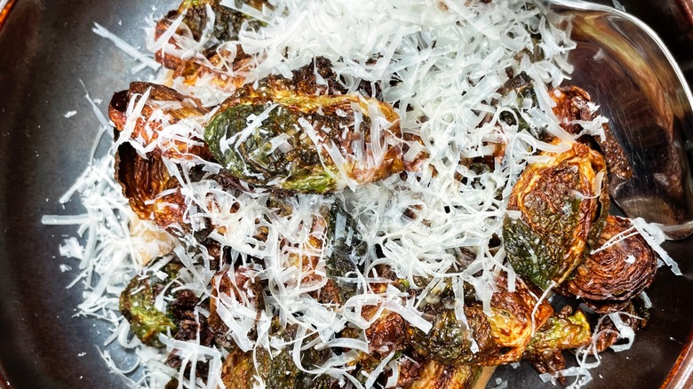 Pan of Brussels sprouts with freshly shredded Parmesan cheese
