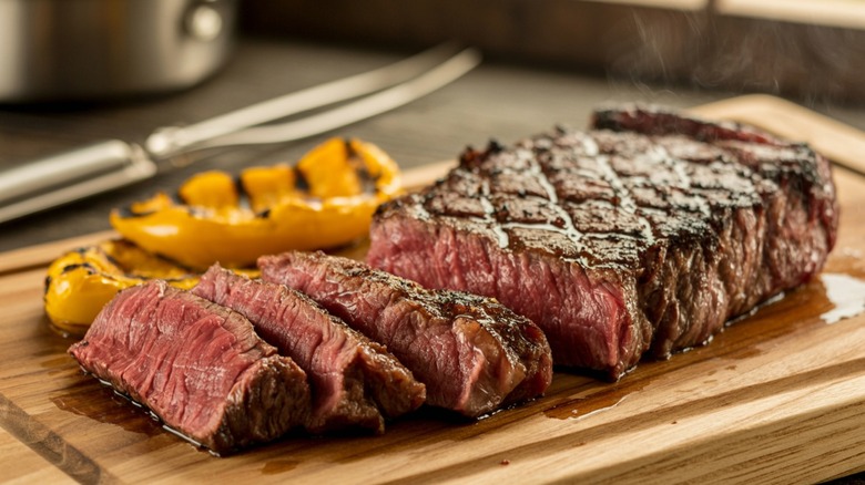 juicy steak cooked medium rare sliced on cutting board