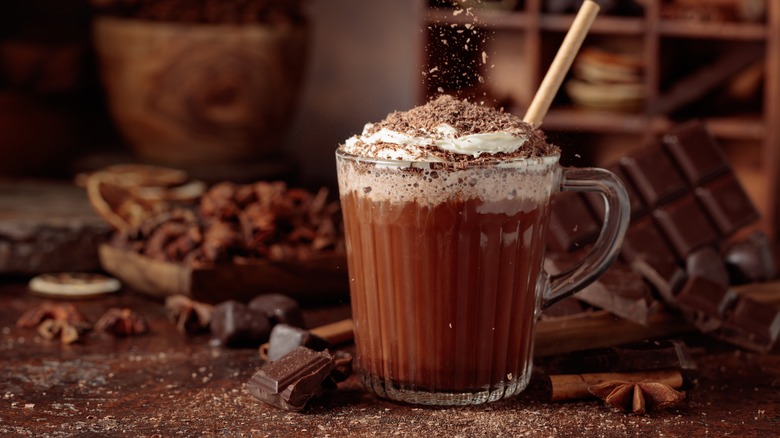 fancy hot chocolate surrounded by chocolate