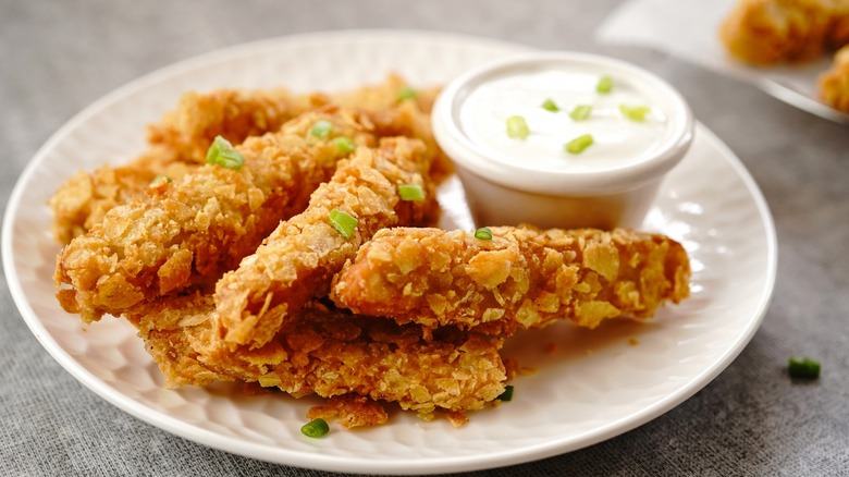 Fried chicken tenders coated in chips