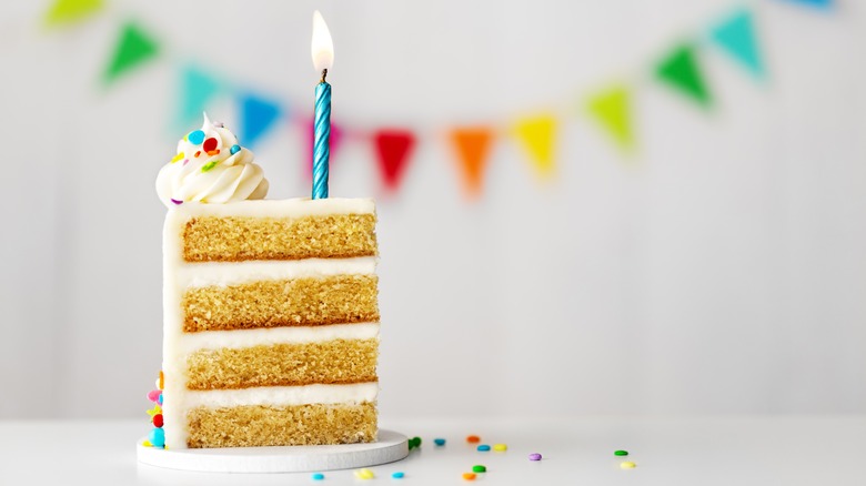 slice of birthday cake with candle