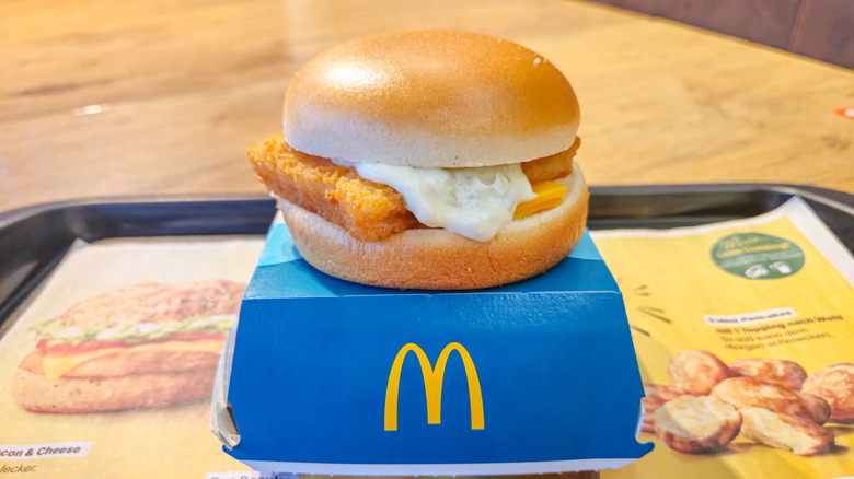 A Filet-O-Fish sandwich from McDonald's sits on top of its container
