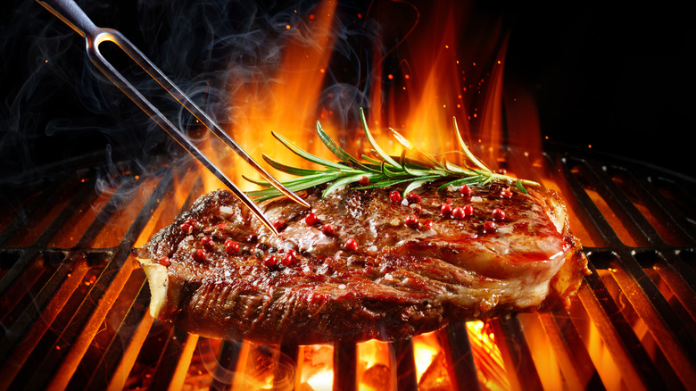 Steak and rosemary on grill