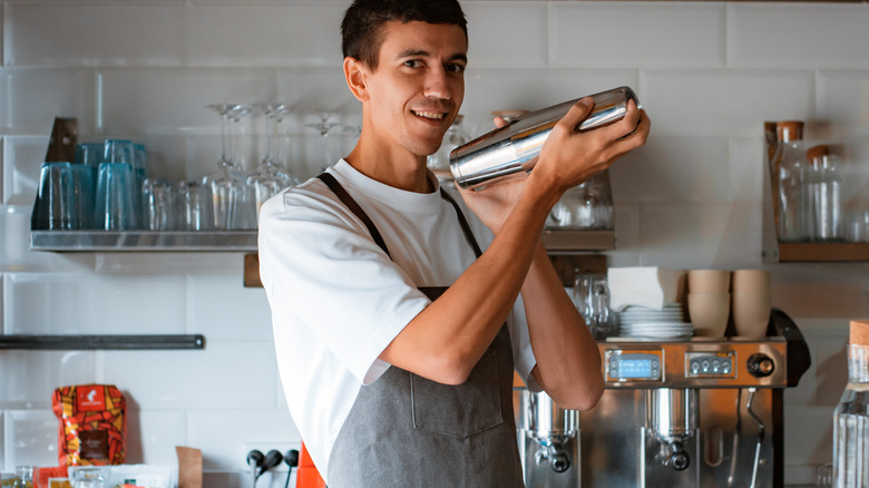 barista making coffee with cocktail shaker