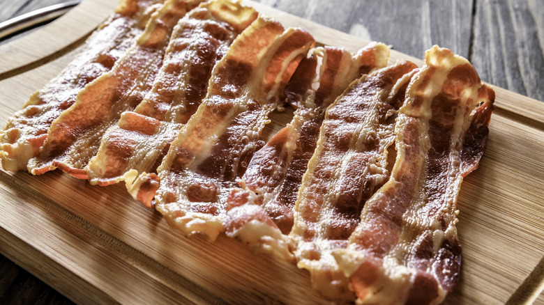 Crispy bacon on wooden board