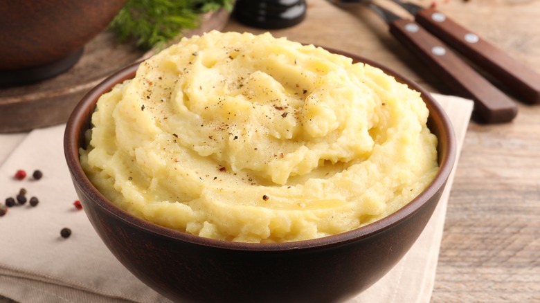 A wooden bowl of mashed potaotes