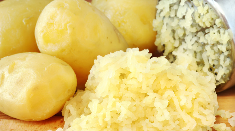 Whole and mashed potatoes with a potato ricer