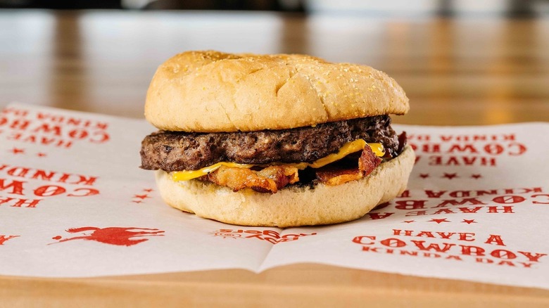 A burger from Roy Rogers on cowboy-branded paper