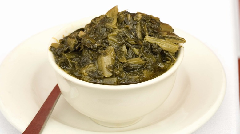 Stewed mustard greens in a white bowl