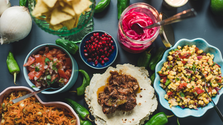 Rice, corn, tortillas, and salsa on table