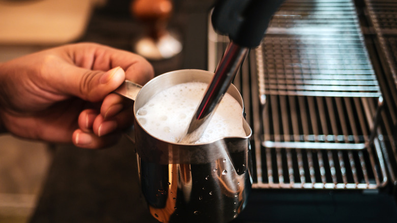 Milk being steamed with a steam wand