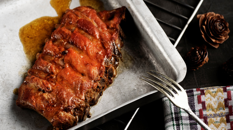 Cooked pork ribs on baking sheet for reheating