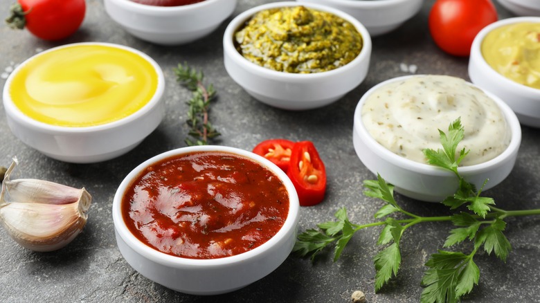 Small bowls containing different sauces and condiments