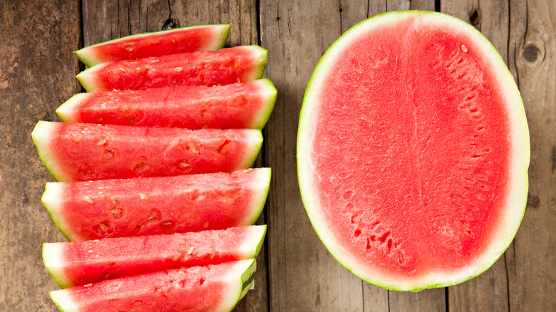 two halves of a watermelon, one of them sliced