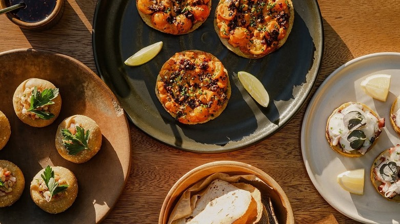 several plates on a table with various mexican appetizers