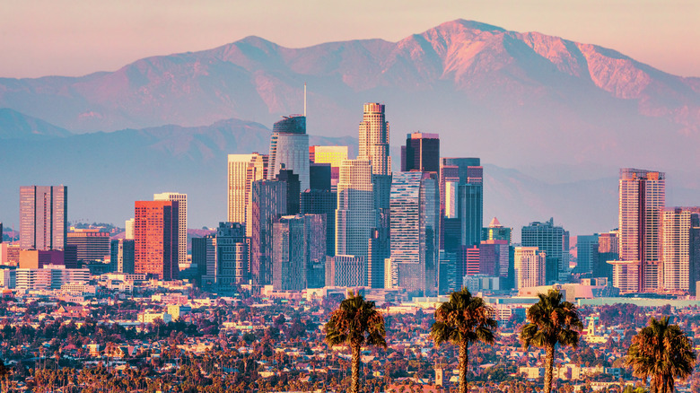 los angeles skyline at sunset with mountains behind the city