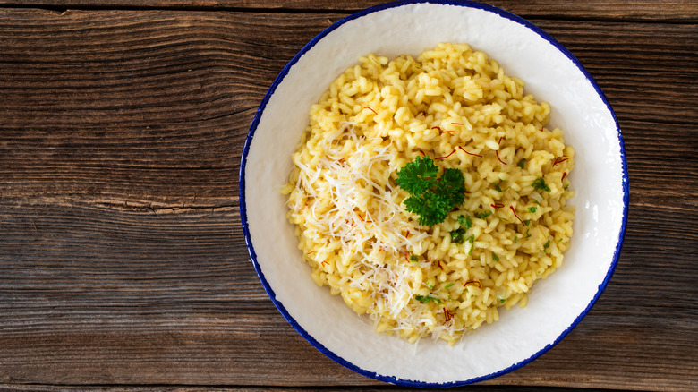 A bowl of risotto alla Milanese on a table