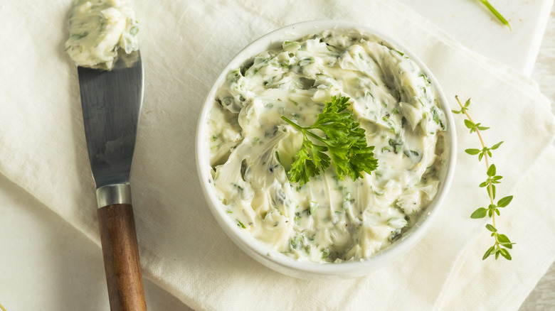 Prepared bowl of herb garlic butter.