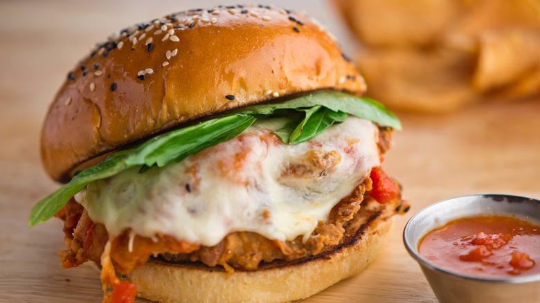 a chicken parm sandwich on a burger bun