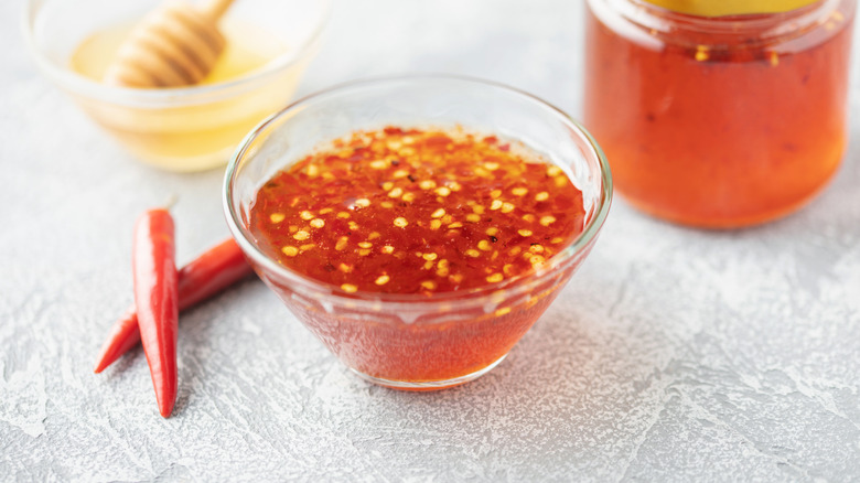 A bowl of hot honey with pepper flakes.