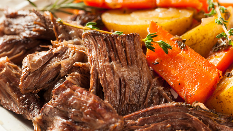 Slow-cooked beef, potato, and carrot meal with herbs