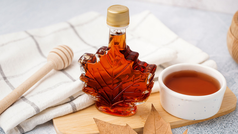 Maple syrup in bowl next to bottle