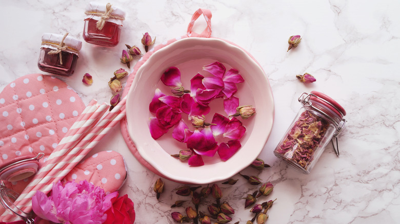 Rose petals in bowl of water