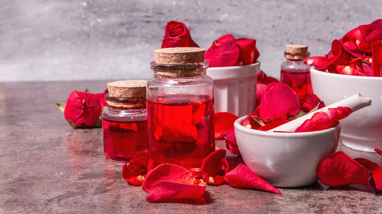 Rose petals in mortar and pestle and rose water