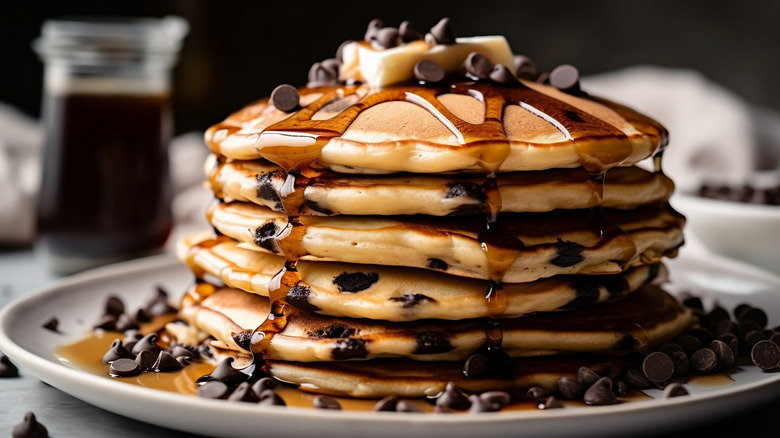 Stack of chocolate chip pancakes drizzled with maple syrup