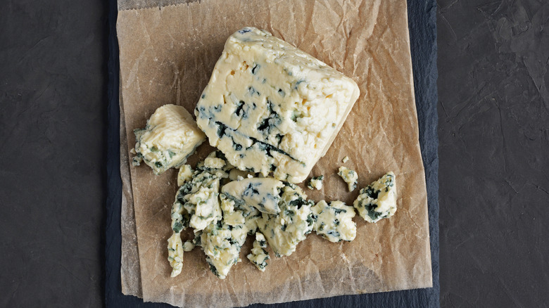 Blue cheese crumbles on paper.