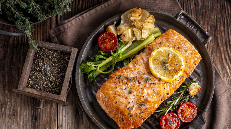 Barbecued salmon drenched with garlic, lemon, herbs, and tomatoes.