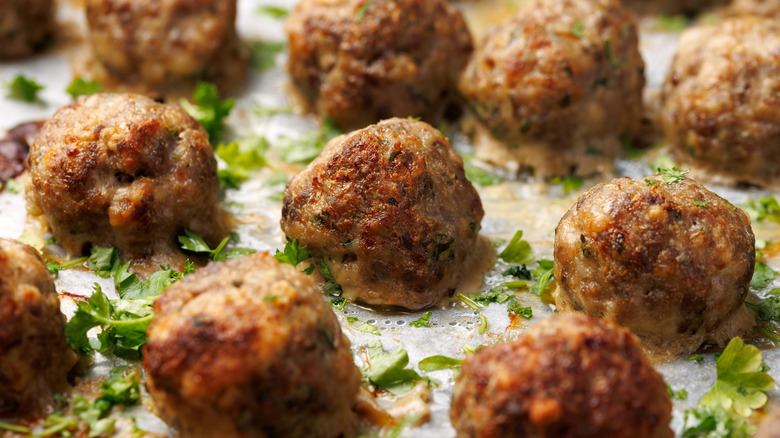 Juicy meatballs lined up on a tray