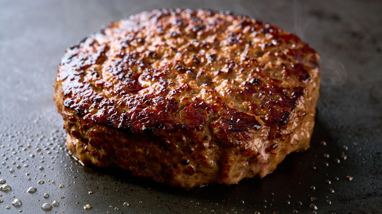 Caramelized burger patty pictured.