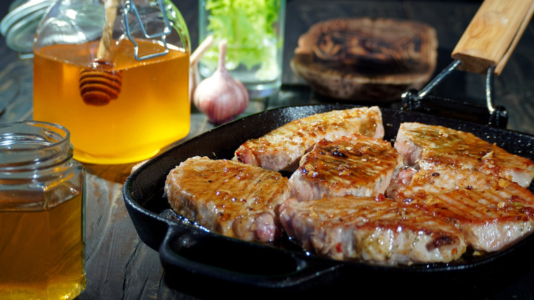 honey and grilled pork chops in a skillet