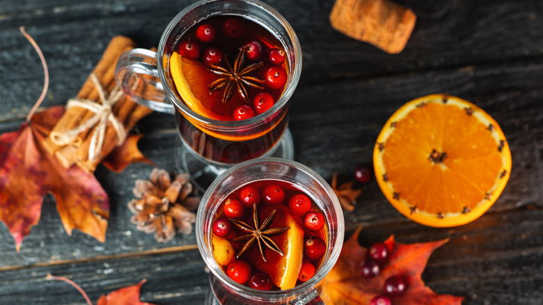 Mulled wine served alongside maple leaves.