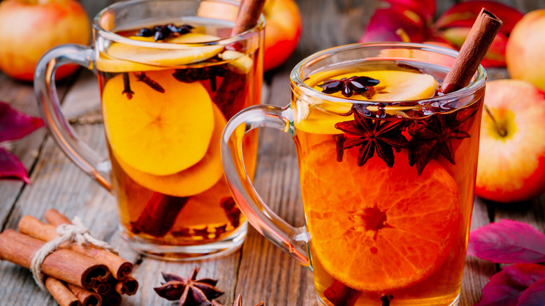 Glasses of mulled wine served with spices.
