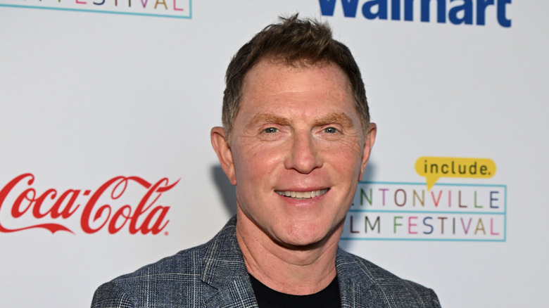 Bobby Flay speaking into a mic.