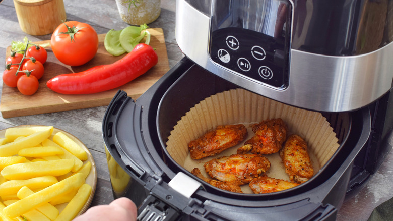 Chicken wings in an air fryer basket