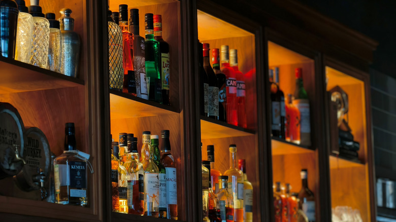 A liquor cabinet in a sunny kitchen.