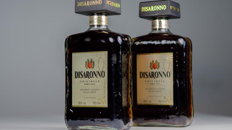 Two bottles of Disaronno sit against a grey background